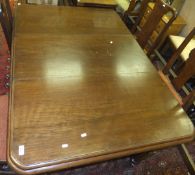 A Victorian mahogany rounded rectangular extending dining table on turned and reeded legs to