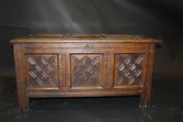 A 19th Century oak coffer in the 17th Century manner with three panel lozenge carved front