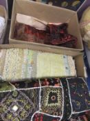 A box containing assorted ethnic patchwork and embroidered wall hangings / bed throws,