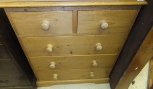 A modern pine chest of two short and three long drawers on bracket feet,