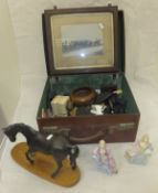 A small vintage suitcase containing a collection of miscellaneous items to include military