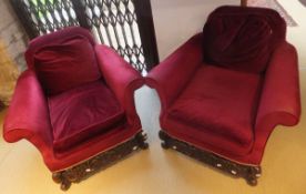 A pair of Carolean style deep seated armchairs with carving to the legs and front stretcher,