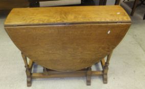 An oak gate-leg dining table and a mahogany sofa coffee table