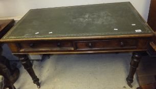 A Victorian mahogany two drawer desk with tooled green leather inset top on four turned legs