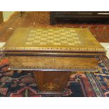 A walnut and inlaid games work table with parquetry inlaid chess board to top,