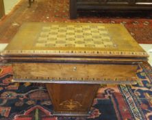 A walnut and inlaid games work table with parquetry inlaid chess board to top,