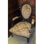 A pair of Victorian mahogany framed salon chairs with serpentine front seat and peach ground