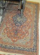 A Persian rug, the central foliate decorated medallion in dark blue,