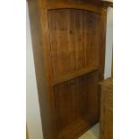 A pine open bookcase with adjustable shelving and moulded cornice