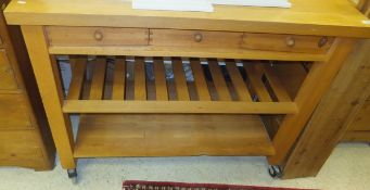 A modern stained beech kitchen island on wheels