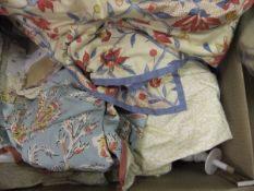 A box containing various curtains, etc.