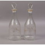 A PAIR OF CUT GLASS DECANTERS AND STOPPE