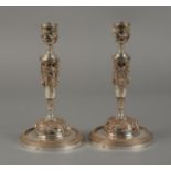 A PAIR OF SILVER PLATED CANDLESTICKS,