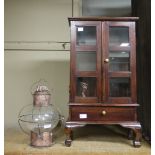 A dark stain and glazed two-door cabinet