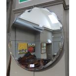 A circular bevelled wall mirror