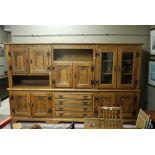 An oak wall unit in three sections, havi