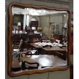 A mahogany stained wall mirror, the beve