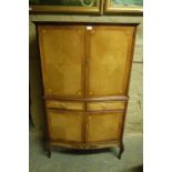 A serpentine fronted drinks cabinet, qua