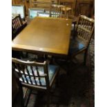 An oak drawer leaf dining table on refec