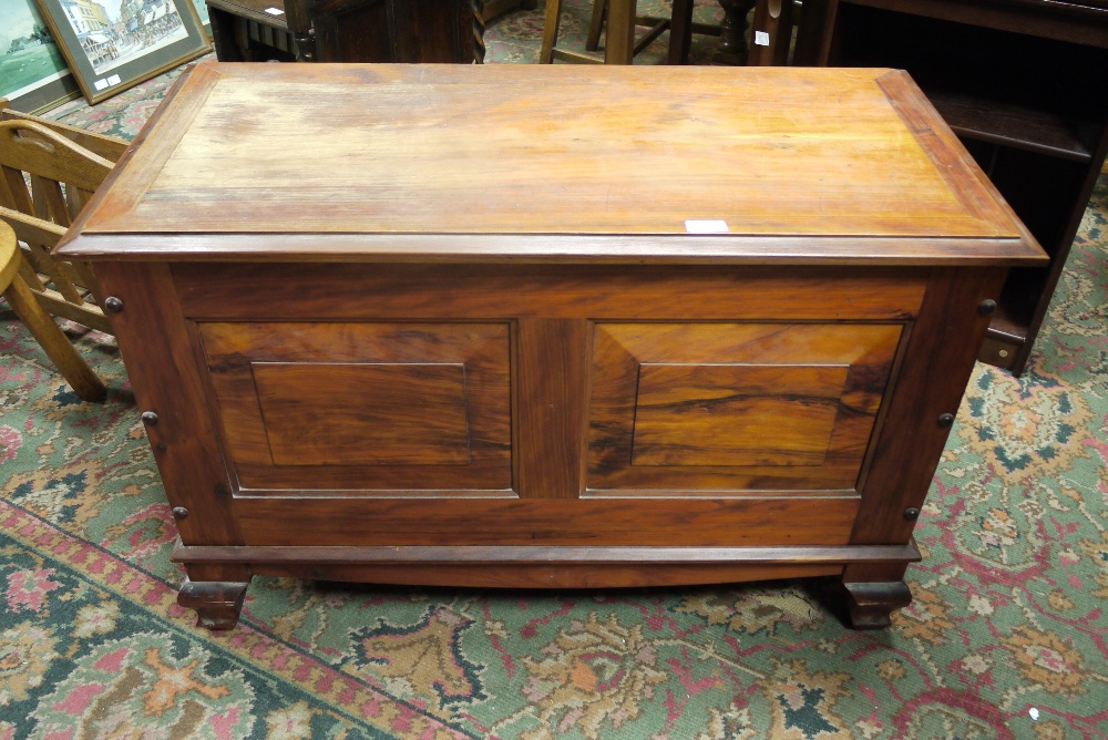 A fruitwood ottoman with twin field pane
