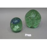 Two green glass dumps, one enclosing a m