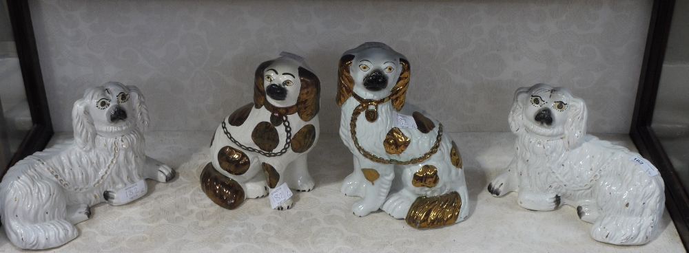 A pair of Staffordshire recumbent spanie