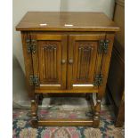 An oak two door cupboard with linen fold