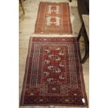 A Bokhara type rug of fox red, ivory and