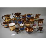 A collection of copper lustre jugs in va