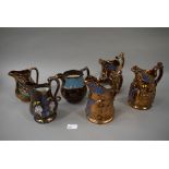 Six various copper lustre jugs