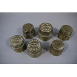 Six brass hub caps, each stamped with va