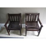 A set of four slatted back wooden garden