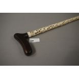 A vertebrae walking cane with treen hand