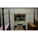 A cream and gilt painted bedroom unit by