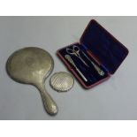 A silver backed hand mirror, a silver po