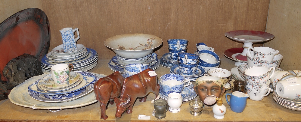 A shelf of assorted tea ware, including