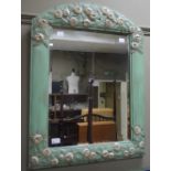 A modern bevel edge wall mirror in a gre