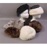 A platinum mink hat and matching tails, an ivory mink hat, an ivory mink and black leather hat,