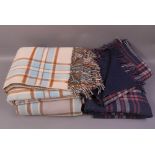 Two navy blue, pink and ivory checked wool travel rugs in two sizes, together with a pale blue,