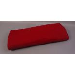 A large length of crimson red wool fabric