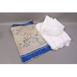 A white crocheted bed throw,