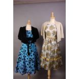 A 1960s black velvet printed blue taffeta style sleeveless cocktail dress with black velvet cape