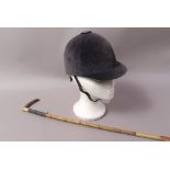 A horn handled riding crop and a velvet riding hat