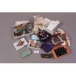 A quantity of vintage needle cases, needles, boxes of pins, buttons,