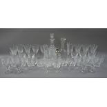 Two trays of cut glassware comprising two decanters, flower vases, goblets,