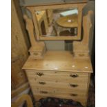 A pine dressing table with square mirrored bevelled plate, two jewellery drawers,