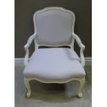 A modern cream painted French style open armchair with beige upholstery