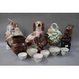 A Staffordshire pottery spaniel, Staffordshire figure of a Scottish couple, an Italian ewer,