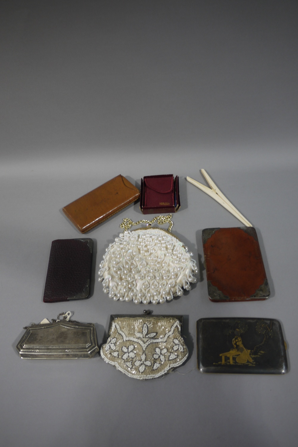 A leather cigar case, a leather purse, a Ronson lighter, a pearl applied purse,