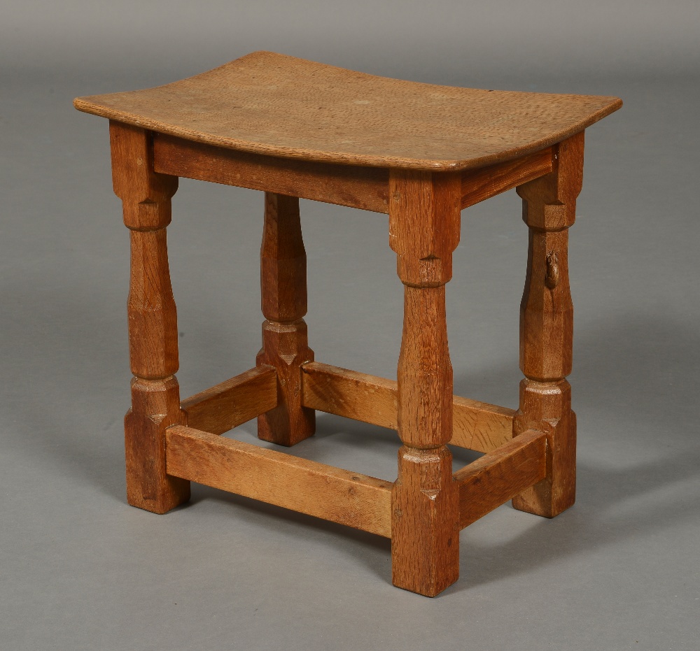 A ROBERT THOMPSON 'MOUSEMAN' OAK STOOL, with dished adzed top of rectangular form,